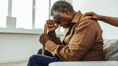 Senior man being cared for by a young nurse in a retirement home