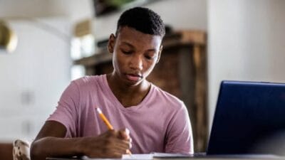 Teenage boy doing schoolwork at home