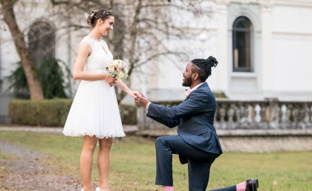 Wedding day as husband on knees