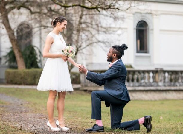 Wedding day as husband on knees