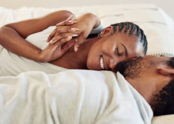 Man and woman sleeping in bed in kenya photo