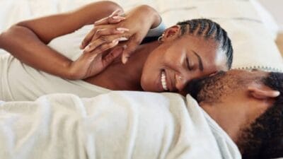 Man and woman sleeping in bed in kenya photo