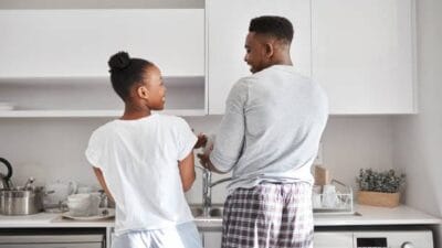 Man and woman washing utensil in the kitchen photo