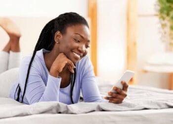 Woman looking at phone as husband searching for her photo