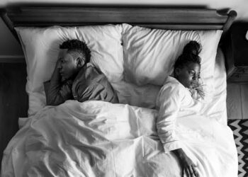 Man and woman distanced themselves in bed photo
