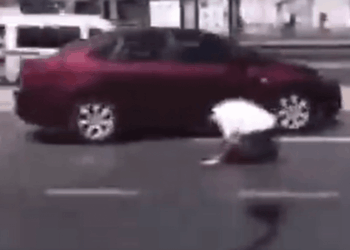 Uk muslim praying on a busy street