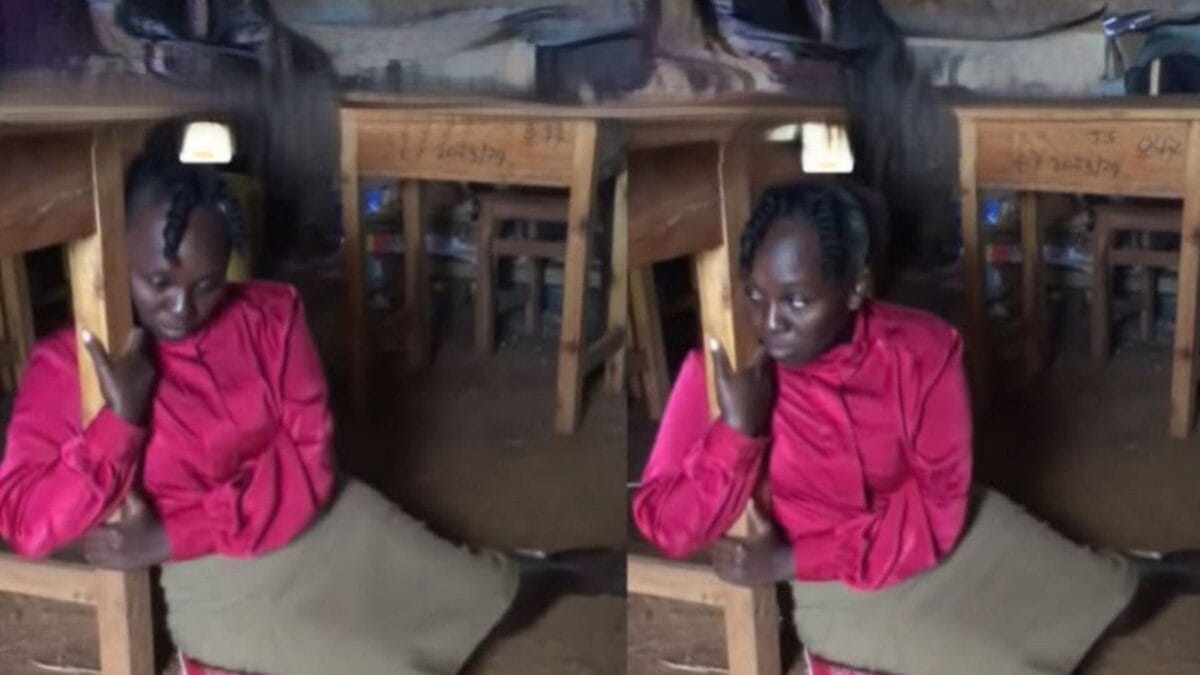 Tigania teacher hugging desk
