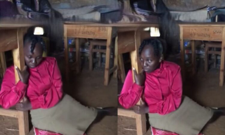 Tigania teacher hugging desk