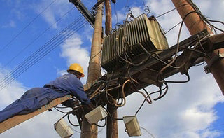 Kenya Power workers fitting transformers. PHOTO| NMG