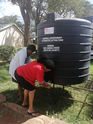 Sabina Chege distributing water tanks the whole county bus stages and markets