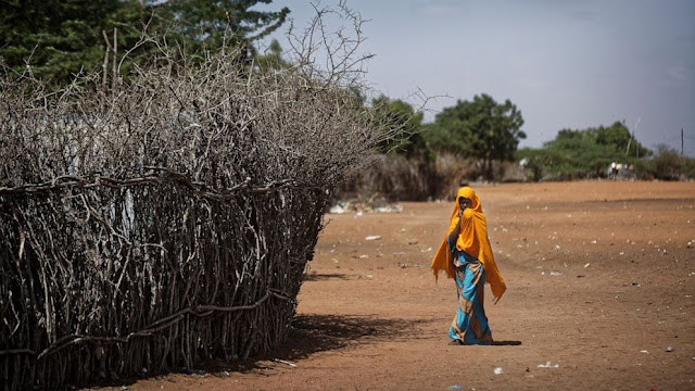 A 17-year-old girl walking A 17-year-old girl walking in Kenya photo