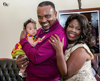 Bishop Allan Kiuna Grandchild with his wife Carthy. PHOTO | BANA Bishop Allan Kiuna holding his first grandchild with his wife Carthy Kiuna.