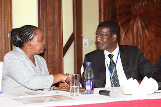 Anne Waiguru, Cabinet Secretary for Devolution and Planning receives a warm handshake from Kenya Power MD&CEO Dr. Ben Chumo during the County Governors Forum. PHOTO | Courtesy KPLC under public scrutiny over allegations of providing false electricity supply figures to the president.