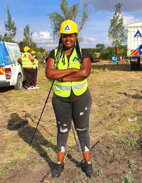 Businesslady Kathy Andrews behind Omosh house photo