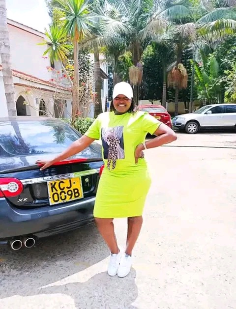 Businesslady Kathy Andrews behind Omosh house photo