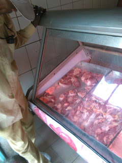 A customer buying Red meat in a butchery in Kenya.