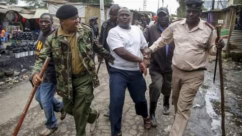 Kaloleni Police officers arresting resident with no facemasks Kaloleni Police officers arresting resident with no facemasks