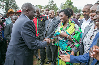 Deputy president William Ruto greets Martha Karua. PHOTO: PSCU "Let farmers take back their title deeds that were tied to these loans." President said before deputy president greeted Martha Karua.