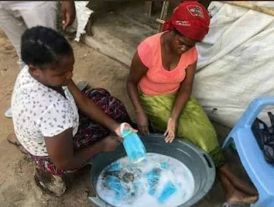Mothers washing used facemasks for resale. PHOTO | BMS Mothers washing used facemasks for resale. PHOTO | BMS