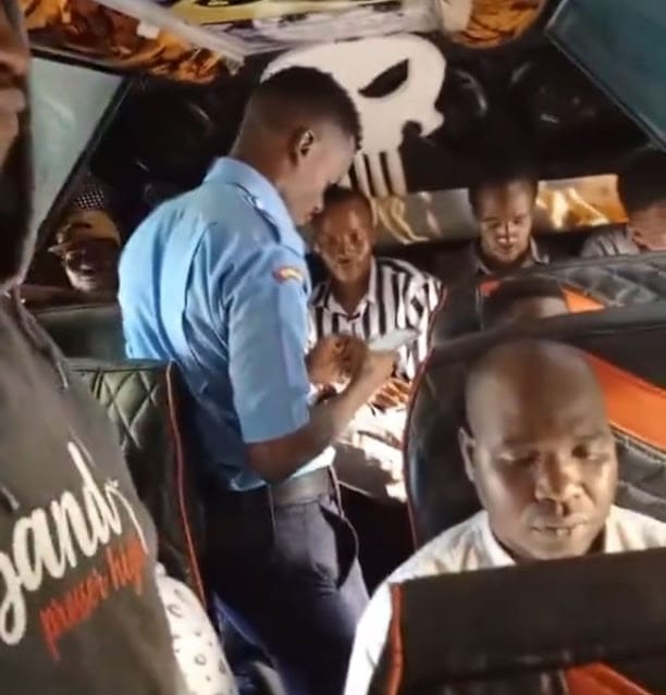 Police officer collecting bus fare