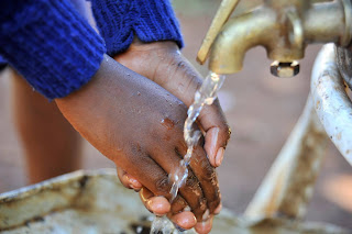 A bomet resident showers her hand on the water day. PHOTO | Courtesy A bomet resident showers her hand on the water day. PHOTO | Courtesy
