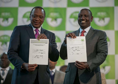 Uhuru Kenyatta with William Ruto being given the Certificate. PHOTO | Courtesy Uhuru Kenyatta with William Ruto being given the Certificate. PHOTO | Courtesy