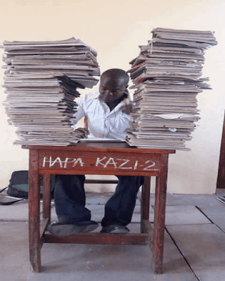 A teacher in staffroom marking. PHOTO | Courtesy A teacher in staffroom marking. PHOTO | Courtesy